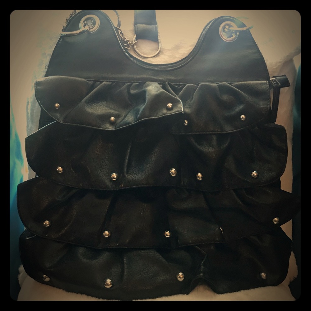 Faux leather black purse with metal studs.
